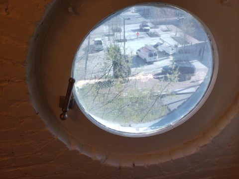 a round window with a view of a parking lot